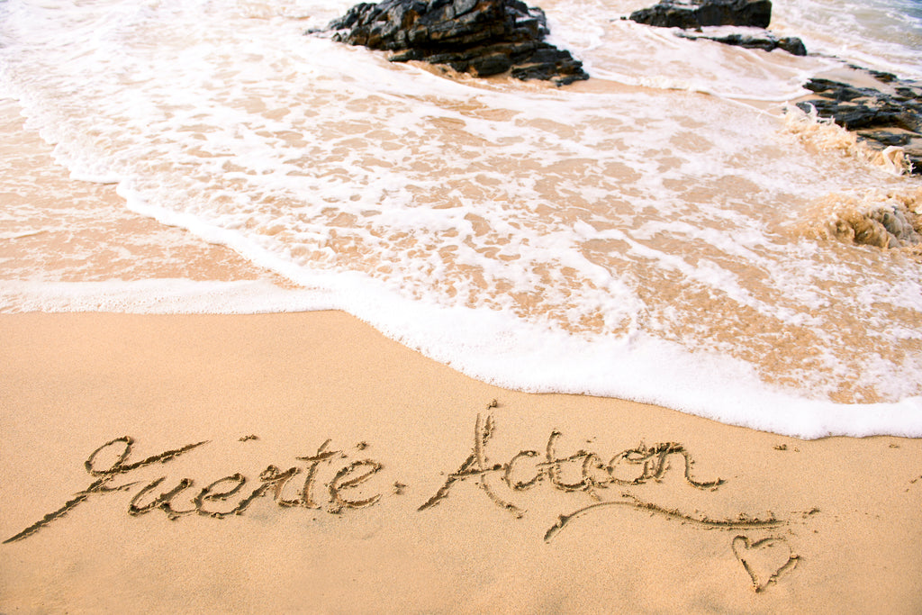Logo Fuerte Action drawn on the sand